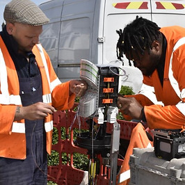 Splicing workstation where two employees are completing work.